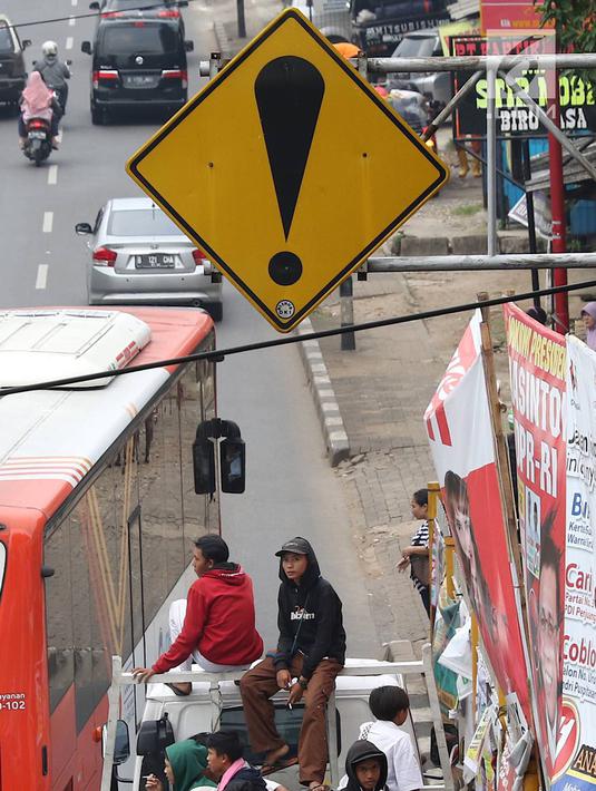 Pelajar menumpang truk terbuka yang melintas di kawasan Lenteng Agung, Jakarta, Senin (8/4). Perilaku buruk tersebut membahayakan keselamatan diri mereka dan pengguna jalan lain. (Liputan6.com/Immanuel Antonius)