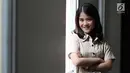 Penyanyi Ashira Zamita tersenyum saat pemotretan di kantor KLY, Gondagdia, Jakarta, Senin (1/10). Ashira Zamita merupakan artis cilik wanita yang pernah bermain di sinetron Cinta Fitri. (Liputan6.com/Herman Zakharia)