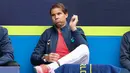 Petenis Spanyol, Rafael Nadal menyaksikan timnya bertanding melawan Australia dalam Turnamen Tenis ATP Cup di Melbourne, Selasa (2/2/2021). Spanyol menang 3-0 atas Australia. (AFP/David Gray)