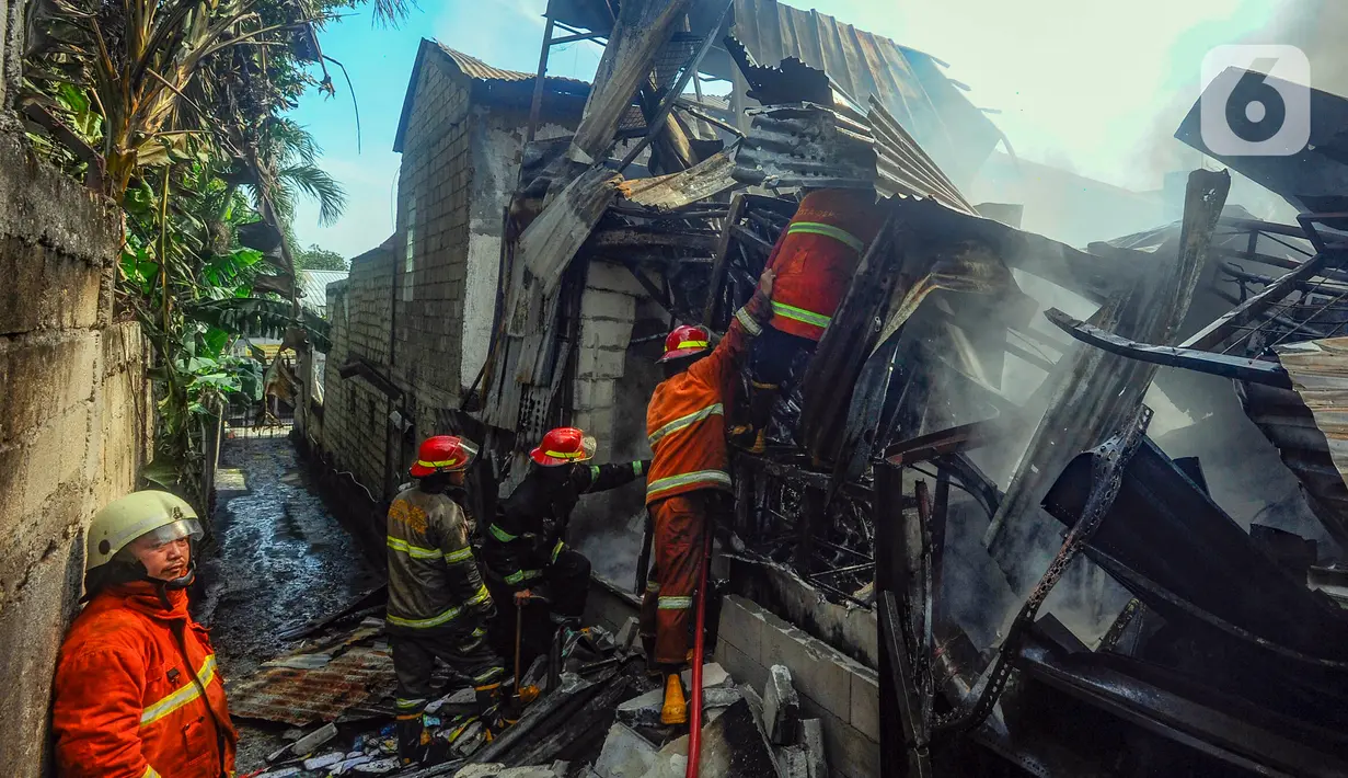 Petugas pemadam kebakaran Pemerintah Kota Depok berusaha memadamkan sisa api kebakaran lapak rongsok di Jalan Karet, Beji, Kota Depok, Jawa Barat, Selasa (5/12/2023). (merdeka.com/Arie Basuki)