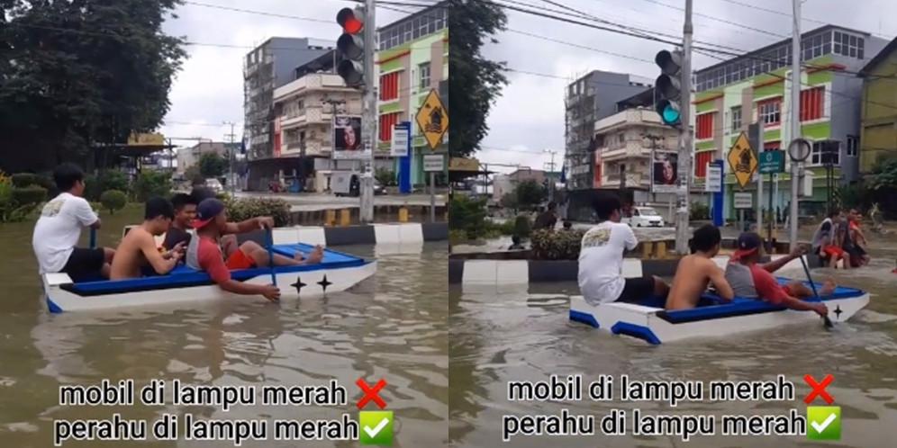 Naik perahu di jalan tergenang banjir (TikTok/@amin.aja_1)