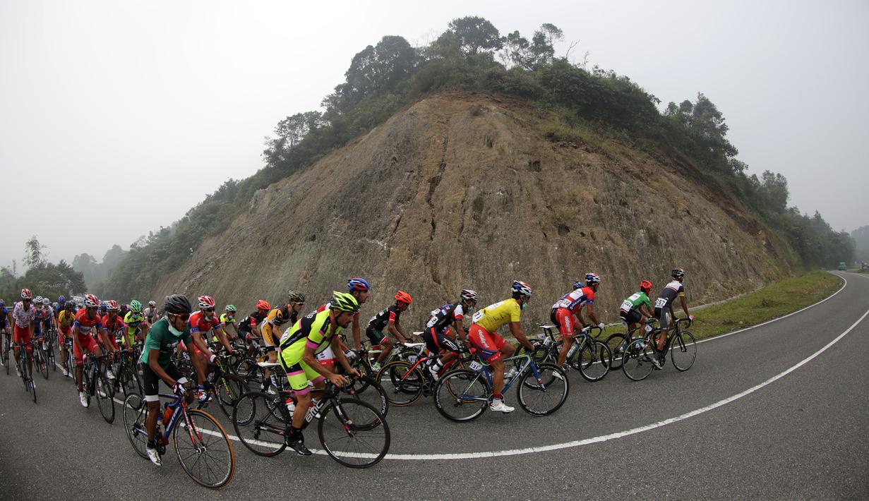 Para pebalap sedang melewati tanjakan di perbukitan Malalak, Kabupaten Agam dalam Etape 6 Tour de Singkarak 2015 antara Bukittinggi-Batusangkar, Kamis (8/10/2015). (Bola.com/Arief Bagus)