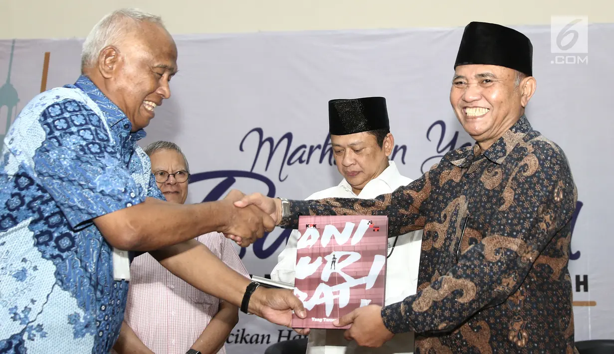 Mantan Ketua KPK Taufiqurrahman Ruki memberikan buku ke Ketua KPK Agus Rahardjo saat peluncuran buku "14 Tahun Perjalanan KPK" di Gedung KPK, Jakarta (23/5). (Liputan6.com/Herman Zakharia)