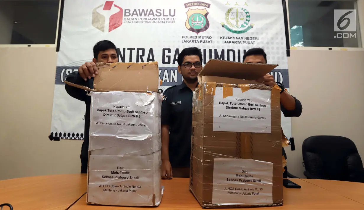 Petugas Bawaslu Jakarta Pusat menunjukkan kardus berisi form C1 Pemilu yang diamankan di Gedung Bawaslu Jakarta Pusat, Senin (6/5/2019). Pihak Bawaslumengatakan masih akan melakukan investigasi dan pemeriksaan terhadap temuan form C1 dari sejumlah daerah itu. (Liputan6.com/Helmi Fithriansyah)