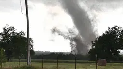 Sebuah tornado besar melewati daerah perumahan dari selatan Wynnewood, Kota Oklahoma, Senin (9/5). Tornado tersebut mendarat dengan cepat dan menghancurkan bangunan yang dilewatinya. (Josh EDELSON/AFP)