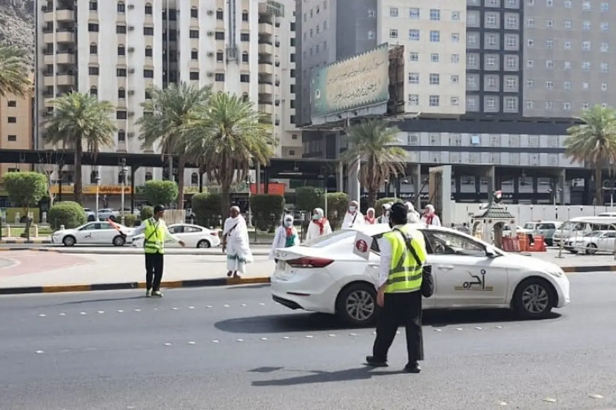 Perjuangan petugas haji dari Indonesia membantu para jemaah menyeberangi jalan di tengah cuaca panas terik Kota Makkah, Arab Saudi. (Foto: Kemenag)