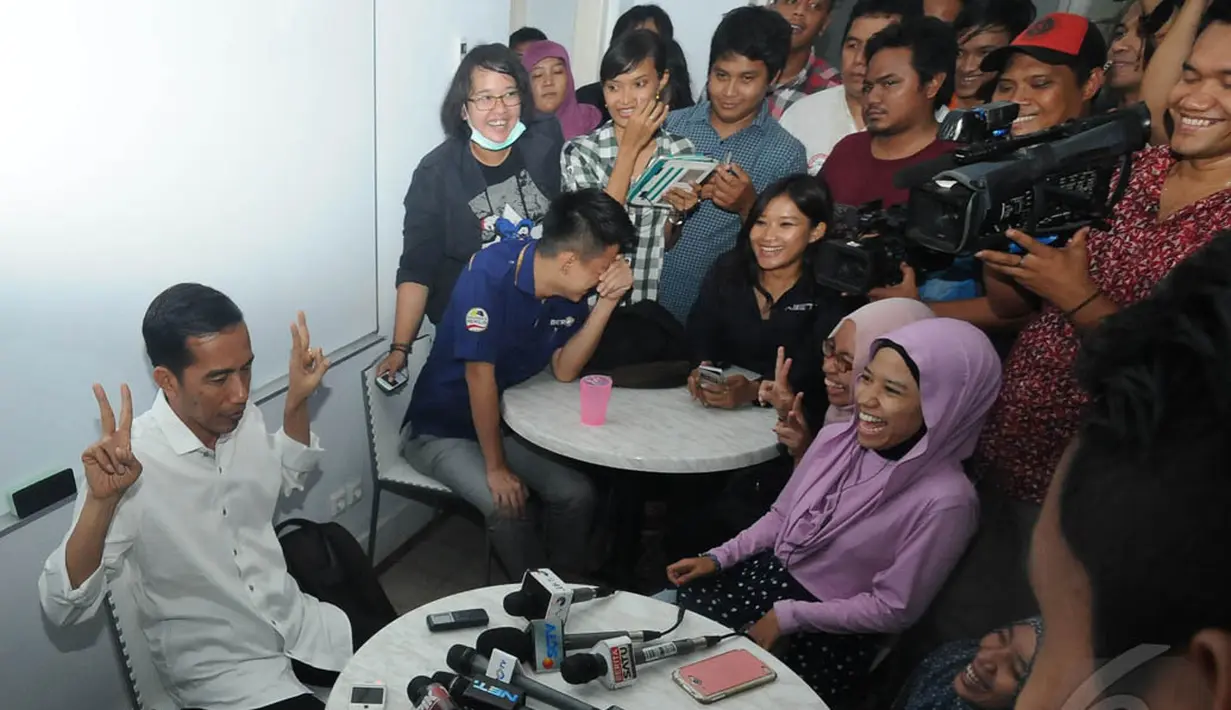 Jokowi bergaya dengan menunjukkan tangannya yang menyimbolkan angka dua. Jokowi ingin mengajak masyarakat untuk mencoblos dirinya yang mendapat nomor urut 2, Lenteng Agung, Jaksel, Senin (9/6/2014) (Liputan6.com/Herman Zakharia) 