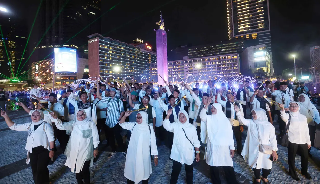 Peserta memegang obor elektrik saat mengikuti acara Transisi Perayaan Imlek 2577 Kongzili menuju Ramadan 1447 H di kawasan Bundaran Hotel Indonesia (HI), Jakarta, Selasa (17/2/2026). (Kapanlagi.com/Budy Santoso)