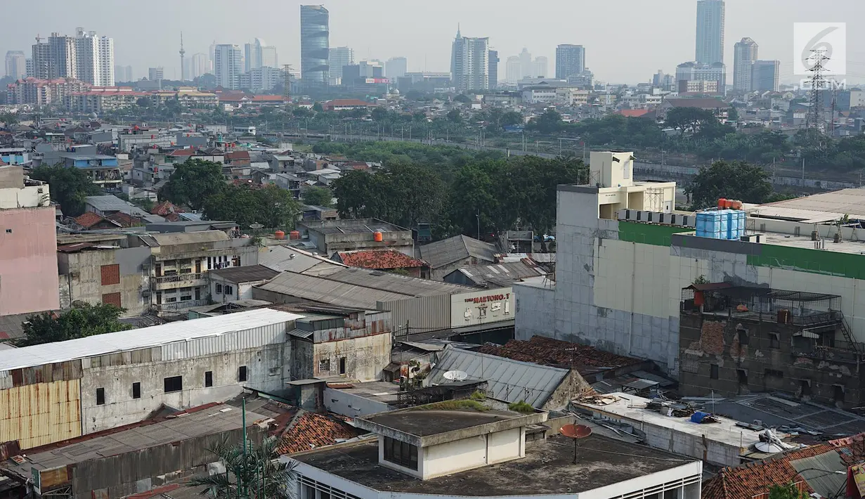 Lansekap pemukiman penduduk berlatar gedung bertingkat terlihat dari Tanah Abang, Jakarta, Selasa (21/5). Laporan Oxford Economics berjudul Global Cities 2018 menyebut Jakarta akan jadi kota dengan jumlah penduduk terbesar di dunia pada 2035, yakni 38 juta jiwa. (Liputan6.com/Immanuel Antonius)