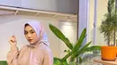 Perpaduan blouse warna pink pastel, kulot putih, dan hijab segi empat warna pink bermotif bisa memberikan kesan lembut pada look-mu. (Instagram/nblh.ayu).