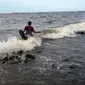 Aktivitas warga di pantai Marunda dan kawasan Si Pitung, Jakarta, Kamis (9/12/2021). Di beberapa titik masih tergenang akibat banjir rob (air laut pasang) dan gelombang  pasang air laut merupakan masalah serius yang dihadapi beberapa wilayah pesisir di Indonesia. (merdeka.com/Imam Buhori)