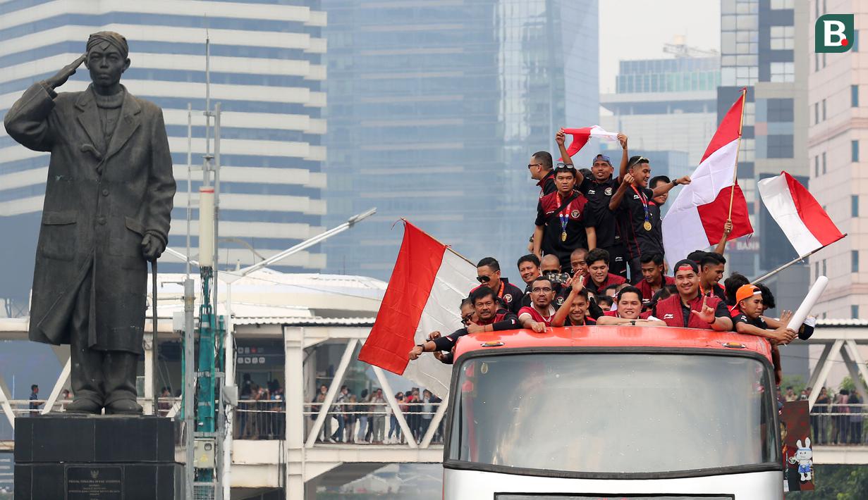 Bus yang ditumpangi Timnas Indonesia U-22 melewati Patung Sudirman saat pawai kontingen Indonesia untuk SEA Games 2023 yang bertajuk Kira87uara yang berlangsung di Jakarta, Jumat (19/05/2023). (Bola.com/Bagaskara Lazuardi)