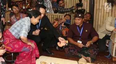 Menteri BUMN Rini Soemarno bersama Kepala Bekraf Triawan Munaf mengunjungi salah satu stand milik perusahaan BUMN selama ajang Pertemuan Tahunan IMF-World Bank Group 2018 di Nusa Dua Bali, Selasa (9/10). (Liputan6.com/Angga Yuniar)