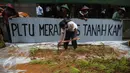Seorang petani berteriak saat menggelar aksi menanam padi di depan Kedubes Jepang, Jakarta, Senin (5/12). Mereka menuntut ganti rugi paska penutupan akses lahan pertanian mereka karena pembangunan PLTU batu bara Batang. (Liputan6.com/Faizal Fanani)