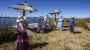 Petugas kesehatan tiba di pulau Uros untuk menyuntik warga dengan vaksin COVID-19 Sinopharm, di danau Titicaca di Puno, Peru, pada 7 Juli 2021. Peru memulai vaksinasi COVID-19 untuk ratusan penduduk asli yang tinggal di pulau terapung Uros, di Danau Titicaca. (Carlos MAMANI / AFP)