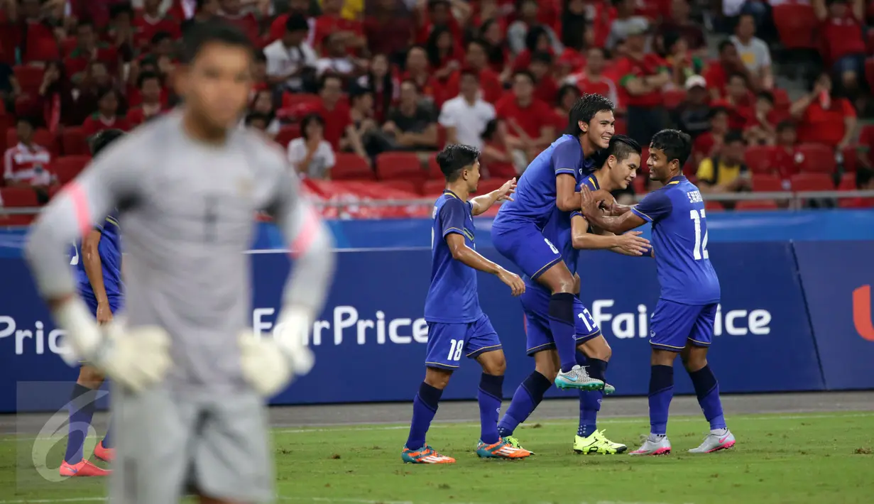 Sejumlah pemain Thailand U-23 melakukan selebrasi usai menjebol gawang Indonesia di laga semifinal sepak bola SEA Games ke-28 di National Stadium Singapore, Sabtu (13/6/2015). Indonesia kalah 0-5. (Liputan6.com/Helmi Fithriansyah)