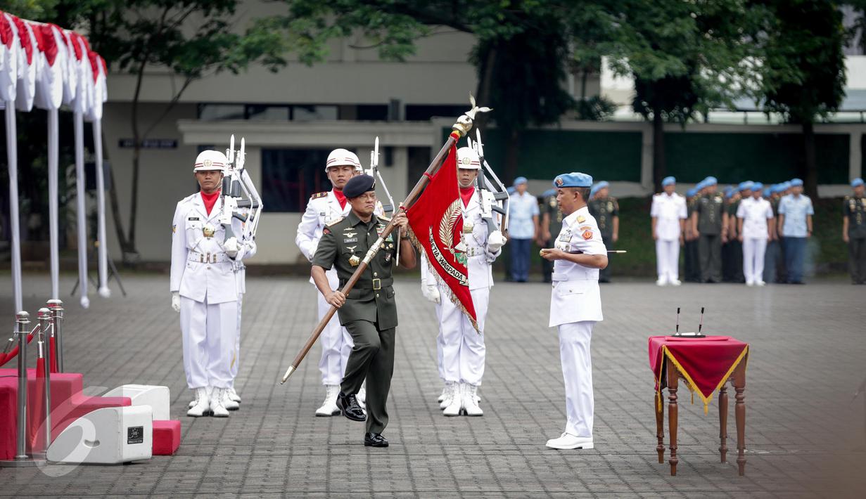 Panglima TNI Jenderal Gatot Nurmantyo bersiap menyerahkan pataka Paspampres Setia Waspada kepada Komandan Paspampres Brigjen (Mar) Suhartono saat prosesi sertijab Danpaspampres di Mako Paspampres, Jakarta Pusat, Selasa (14/3). (Liputan6.com/Faizal Fanani)