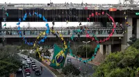 Pendaki profesional membuat Bentuk Cincin Olimpiade 2016 di sebuah jembatan di Sao Paulo, Brasil (31/7). Aksi ini dilakukan untuk menyambut dan memeriahkan Olimpiade 2016. (REUTERS/Paulo Whitaker) 