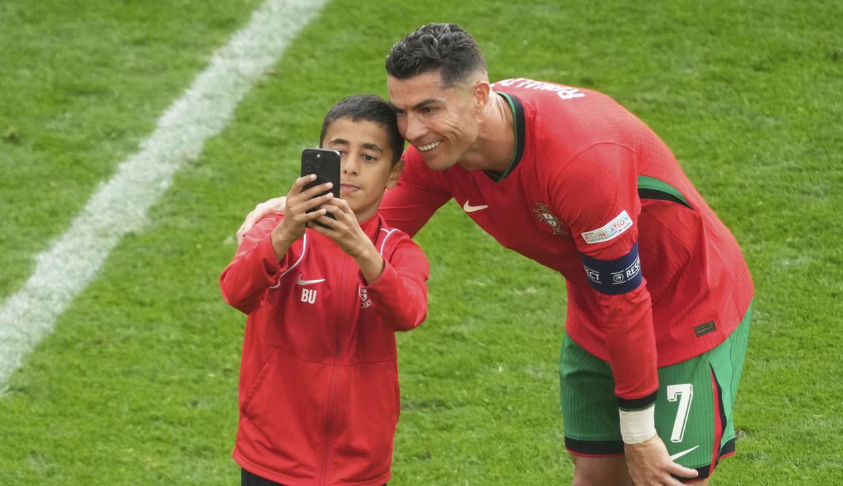 Salah satunya adalah seorang bocah yang sukses menerobos lapangan dan mengecoh petugas kemananan hingga berhasil foto bersama sang idola. (AP Photo/Michael Probst)