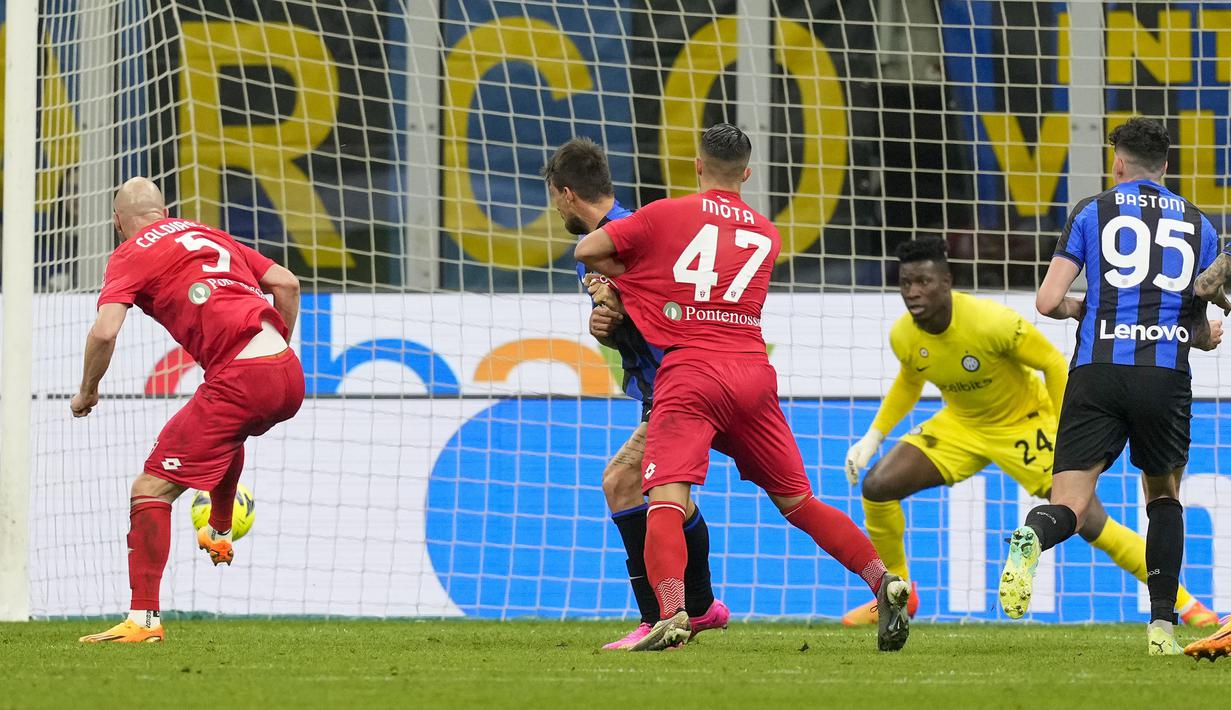 Pemain Monza, Luca Caldirola (kiri) mencetak gol ke gawang Inter Milan saat laga lanjutan Liga Italia 2022/2023 melawan Monza di Giuseppe Meazza, Milan, Minggu (16/04/2023) WIB. Nerazzurri kalah dengan skor 0-1. (AFP/Gabriel Bouys)