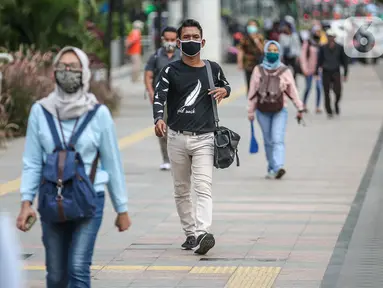 Suasana jam pulang kerja di jalur pedestrian kawasan Sudirman, Jakarta, Senin (22/6/2020). Pemprov DKI Jakarta mulai menerapkan perubahan sif kerja dengan waktu jeda tiga jam, yaitu pukul 07.00-16.00 pada sif pertama dan pukul 10.00-19.00 pada sif kedua. (Liputan6.com/Faizal Fanani)