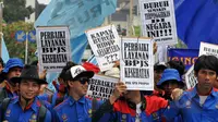 Ribuan buruh membawa aneka tulisan saat aksi May Day di depan Istana Negara, Jakarta, Jum'at (1/5/2015). Lebih dari 100.000 buruh memenuhi jalanan Jakarta dan beraksi di depan Istana Merdeka. (Liputan6.com/Andrian M Tunay) 