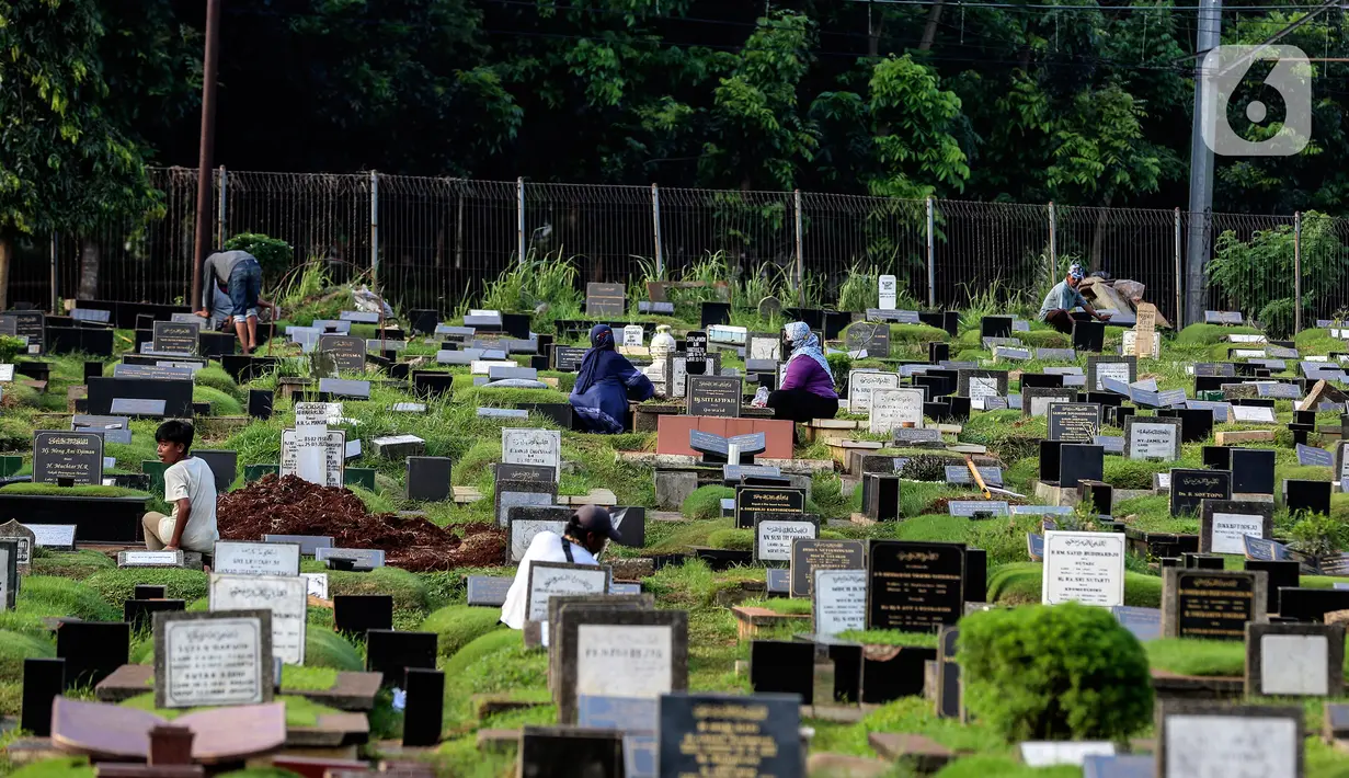 Warga berziarah di makam keluarganya di Tempat Pemakaman Umum (TPU) Tanah Kusir, Jakarta, Selasa (29/3/2022). TPU setempat semakin banyak dikunjungi warga yang melakukan tradisi ziarah kubur menjelang Ramadhan. (Liputan6.com/Johan Tallo)