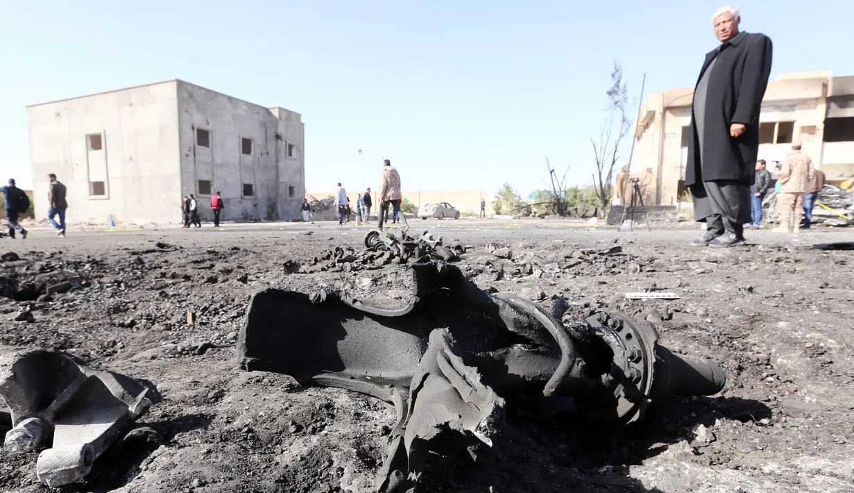 Petugas memeriksa lokasi bom truk yang meledak di sebuah sekolah polisi di kota Zliten, wilayah barat Libya, Kamis (7/1). Belum ada yang mengaku bertanggung jawab terkait serangan bom yang menewaskan sedikitnya 50 orang tersebut. (AFP PHOTO/MAHMUD Turkia)
