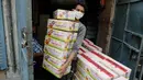 Seorang pekerja India membawa paket bihun di sebuah pabrik di Prayagraj, India pada 25 April 2020. Bihun diminati di kalangan Muslim ketika mereka berbuka puasa selama bulan suci Ramadan. (AP Photo/Rajesh Kumar Singh)