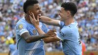 Phil Foden merayakan gol keempat Manchester City bersama Savinho dalam laga Grup G Piala Dunia Antarklub melawan Juventus di Orlando, Florida,&nbsp;Jumat (27/6/2025). (AP Photo/Phelan Ebenhack)