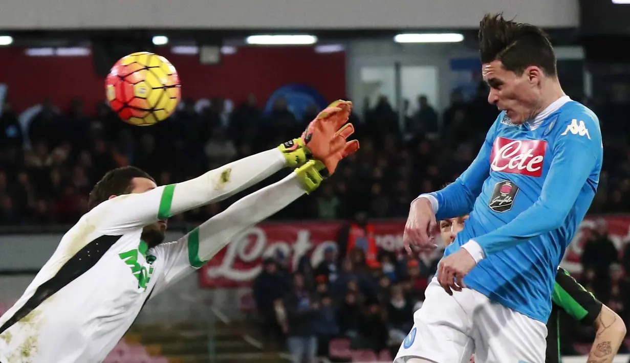 Pemain Napoli, Jose Maria Callejon menyundul bola saat dihalangi kiper Sassuolo, Andrea Consigli (kiri) pada lanjutan Italia Serie A antara Napoli vs Sassuolo di Stadion  San Paolo, Naples, Sabtu (16/1/2016).  (AFP Photo/Carlo Hermann)