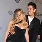 Penyanyi Mariah Carey dan kekasihnya, Bryan Tanaka menghadiri acara after party Golden Globes di California, Minggu (7/1). Kemesraan Mariah Carey dan pacar brondongnya tak pelak menjadi pemandangan yang sayang dilewatkan (Frazer Harrison/GETTY IMAGES/AFP)