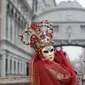 Peserta menggunakan kostum dan topeng saat mengikuti Karnaval Venesia di Piazza San Marco, Italia, Sabtu (30/1). Dalam acara tahunan ini, peserta mengenakan kostum ala Venesia abad ke-18 dan topeng-topeng unik menutupi wajah (REUTERS/Alessandro Bianchi)