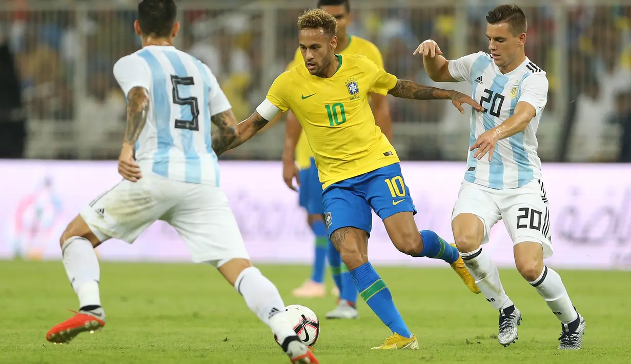 Striker Brasil, Neymar, berusaha melewati pemain Argentina pada laga persahabatan di Stadion King Abdullah, Jeddah, Selasa (16/10/2018). Brasil menang 1-0 atas Argentina. (AFP/STR)