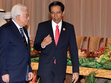Presiden RI, Jokowi (kanan) berbincang dengan Presiden Palestina, Mahmoud Abbas sesaat sebelum acara foto bersama dengan peserta KTT Luar Biasa Organisasi Kerja sama Islam (OKI) di Jakarta Convention Center, Senin (7/3). (Liputan6.com/Faizal Fanani)