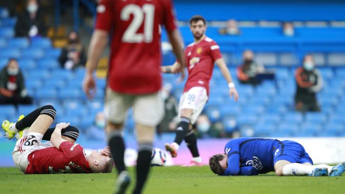 Gelandang Manchester United, Scott McTominay dan gelandang Chelsea, Mason Mount terbaring kesakitan di lapangan pada pertandingan lanjutan Liga Inggris di Stamford Bridge Stadium di London, Inggris, Minggu (28/2/2021). Man Utd berada di urutan kedua dengan 50 poin. (AP Photo/Ian Walton, Pool)