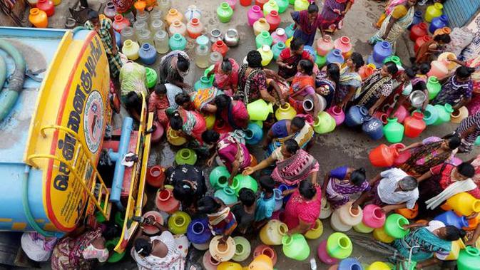 Warga membawa wadah-wadah saat mengantre untuk mengisi air dari truk tangki di Kota Chennai, India, Rabu (19/6/2019). Masyarakat di banyak wilayah India saat ini berusaha bertahan hidup akibat dilanda kekeringan dan krisis air yang parah. (AP Photo/R. Parthibhan)