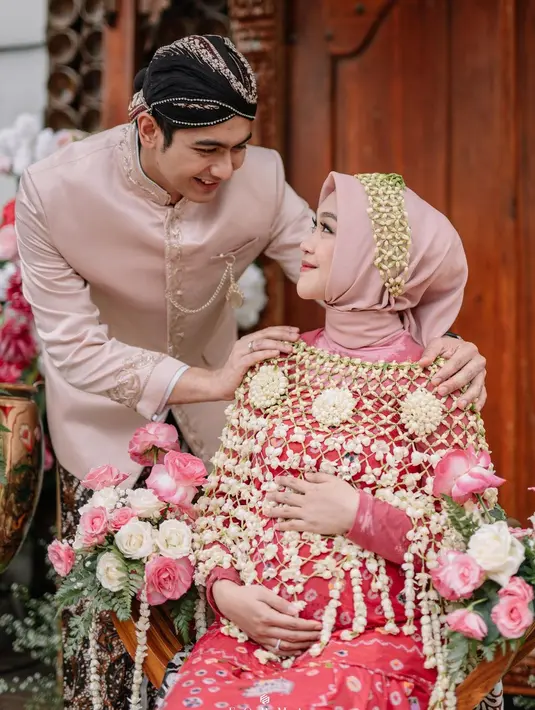 Ria Ricis dan sang suami Teuku Ryan juga melakukan acara Mitoni sebelum menyambut kehadiran anak mereka. Ria Ricis dan Teuku Ryan memilih busana bernuansa merah muda yang lembut dan serasi. Ria Ricis sendiri dibalut batik jumputan yang memesona. [Foto: Instagram/riaricis1795]