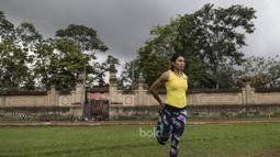 Atlet atletik Indonesia, Maria Londa, melakukan pemanasan sebelum latihan jelang SEA Games 2017 di Lapangan umum Mengwi, Bali, Minggu (10/7/2017). (Bola.com/Vitalis Yogi Trisna)