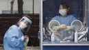 Seorang pekerja medis memegang kipas angin portabel selama panas terik sementara petugas polisi menjalani tes COVID-19 di klinik darurat di Badan Kepolisian Metropolitan Seoul di Seoul, Korea Selatan, Rabu, (19/8/2020). (AP Photo / Ahn Young -joon)