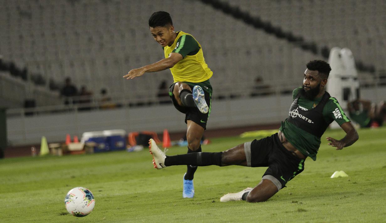 Bek Timnas Indonesia, Yanto Basna, berusaha menghalau tendangan Febri Hariadi, saat latihan jelang laga kualifikasi Piala Dunia di SUGBK, Jakarta, Senin (2/9). Indonesia akan berhadapan dengan Malaysia. (Bola.com/M Iqbal Ichsan)