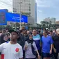 Pasangan bakal calon gubernur dan bakal calon wakil gubernur Jakarta, Pramono Anung-Rano Karno menyambangi kawasan car free day di Bundaran Hotel Indonesia (HI) Jakarta, Minggu (1/9/2024). (Liputan6.com/Muhammad Radityo Priyasmoro)