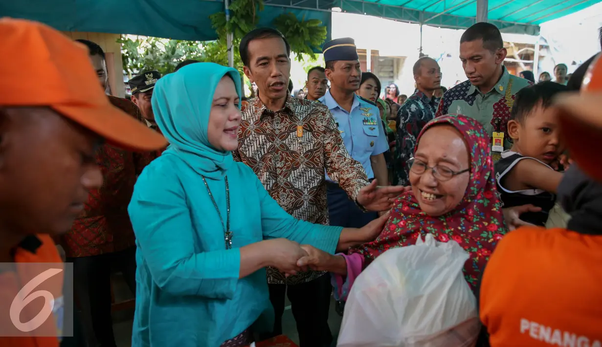 Presiden Joko Widodo didampingi Ibu Negara Iriana membagikan paket sembako saat blusukan ke Kedoya dan Petamburan, Jakarta, Selasa (1/9/2015). Selain sembako, Presiden Jokowi juga membagikan buku dan baju kepada anak-anak. (Liputan6.com/Faizal Fanani)