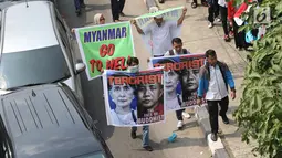 Sejumlah peserta aksi membawa poster dan spanduk saat melintas di kawasan Bundaran HI, Jakarta, Rabu (6/9). Mereka akan menggelar unjuk rasa terkait solidaritas Rohingya di kantor Kedubes Myanmar. (Liputan6.com/Immanuel Antonius)