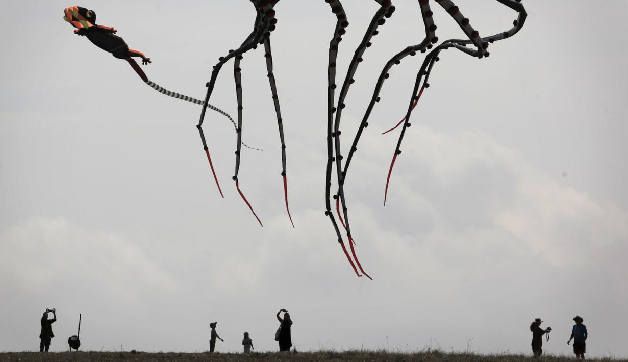 Bagian dari Layang-layang raksasa terlihat saat orang-orang mengambil bagian dalam Varvara Kite Fest di Desa Varvara, pesisir Laut Hitam, Bulgaria, Jumat (27/8/2021). Penyelenggara mengatakan menerbangkan layang-layang seperti melepaskan semua masalah Anda di langit. (AP Photo/Valentina Petrova)