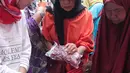 Warga tengah membeli daging murah di Jakarta, Minggu (21/2). Harga daging sapi lokal terjangkau dengan harga Rp85.000 per kg untuk masyarakat dan UKM (Usaha Kecil dan Menengah). (Liputan6.com/Angga Yuniar)
