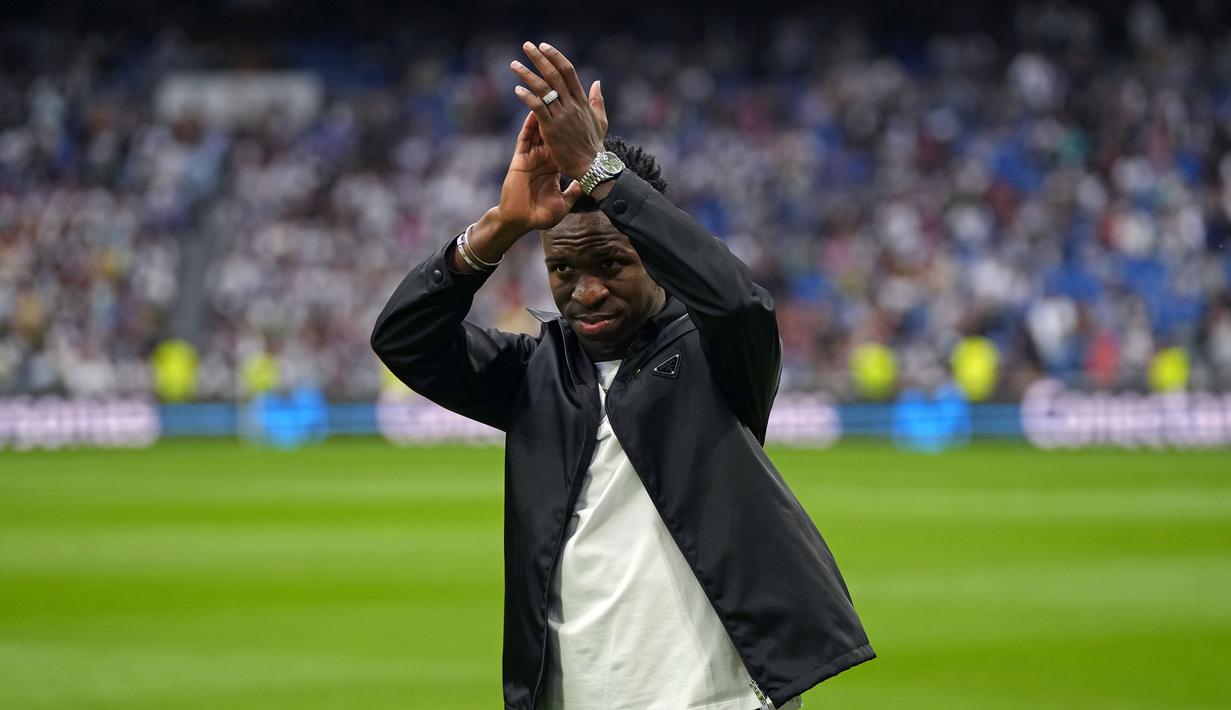 Pemain Real Madrid, Vinicius Jr memberikan tepuk tangan pada laga lanjutan Liga Spanyol 2022/2023 antara Real Madrid melawan Rayo Vallecano pada Kamis (25/05/2023) dini hari WIB. Los Blancos memberikan aksi solidaritas sebelum laga tersebut setelah pemain Brasil itu menjadi korban rasisme pada Minggu (21/05/2023) lalu. (AP Photo/Manu Fernandez)