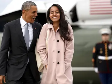 Presiden AS, Barrack Obama berjalan bersama putrinya, Malia, saat akan menaiki pesawat Air Force One dari Bandara O'Hare, Chicago, Kamis (7/4/2016). (REUTERS/Kevin Lamarque)