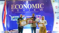 Direktur Utama Majalah Econimic Review Irlisa Rachmadiana, memberikan penghargaan yang diterima langsung Presiden Direktur Pertamina Foundation Agus Mashud S. Asngari, di Mercure Convention Center Hotel, Sabtu (29/6/2024). (Liputan6.com)