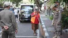 Petugas Satpol PP memberikan sanksi menyapu kepada warga yang tidak menggunakan masker di kawasan Pasar Baru, Jakarta, Jumat (21/8/2020). Sanksi tersebut dilakukan sebagai bagian dari upaya pencehagan penyebaran virus covid-19. (Liputan6.com/Immanuel Antonius)